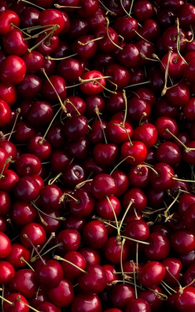 A vibrant pile of ripe red cherries showcasing freshness and abundance.